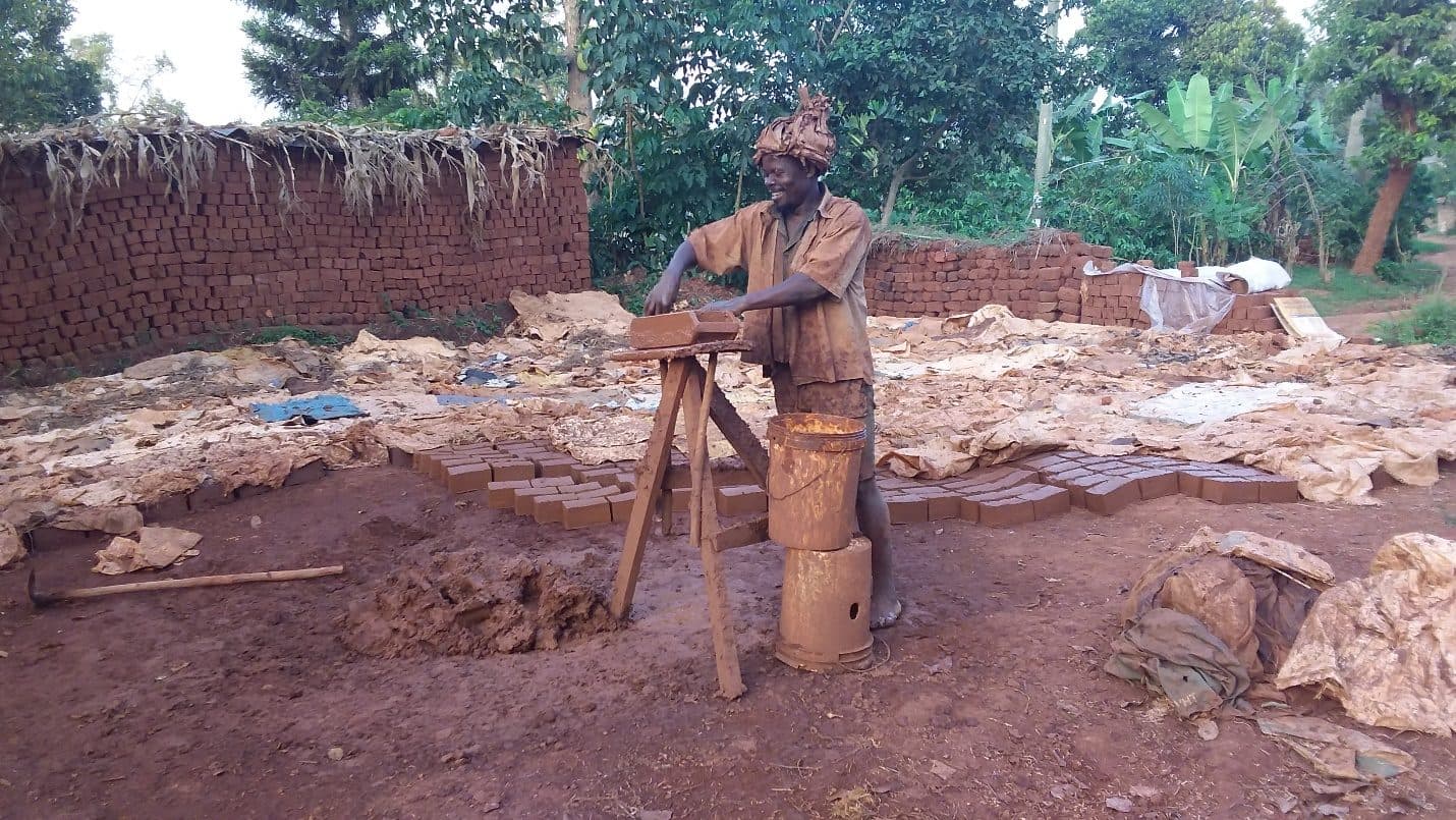 Lumbuye Saulo shaping bricks by hand at his brickmaking site in Kirangira, Mukono